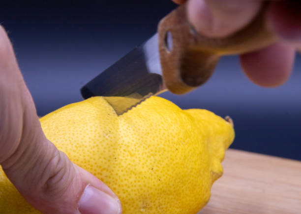 istock Hands of man cutting lemons on cutting board 1406063457