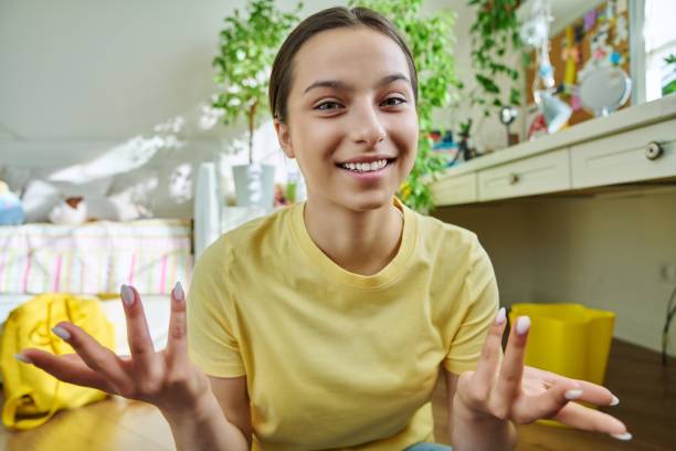 istock Teenage female student having video call, looking at webcam 1406063587