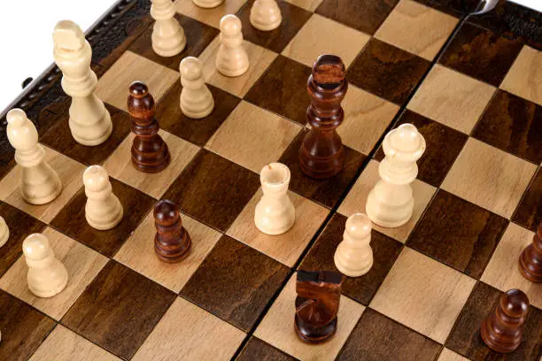 Photo of Beige Brown Wooden chess different pieces figures standing on chessboard. Closeup game concept competition, Classic Tournament.