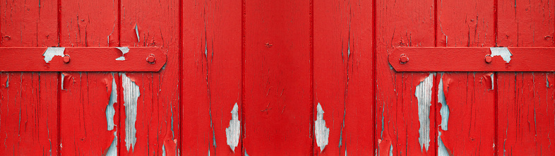 old abstract red colorful painted exfoliate peeled off rustic wooden boards, wooden gate, wooden door texture - wood wall background banner panorama long shabby