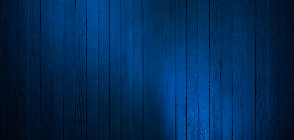 Spotlight reflected on dark blue old wall. The texture of the old wooden wall