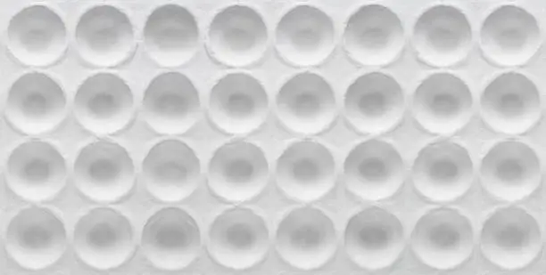 White round textured cardboard. Round geometric pits on cardboard
