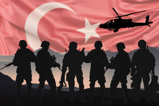 Silhouettes of soldiers with Turkish flag background stock photo