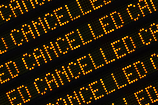 Cancelled Sign Closeup A Close Up Of The Word Cancelled Repeated Multiple Times On A Sign At A Station Or Airport delayed sign photos stock pictures, royalty-free photos & images