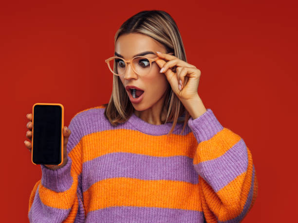 istock Beautiful emotional woman using smart phone 1406070821