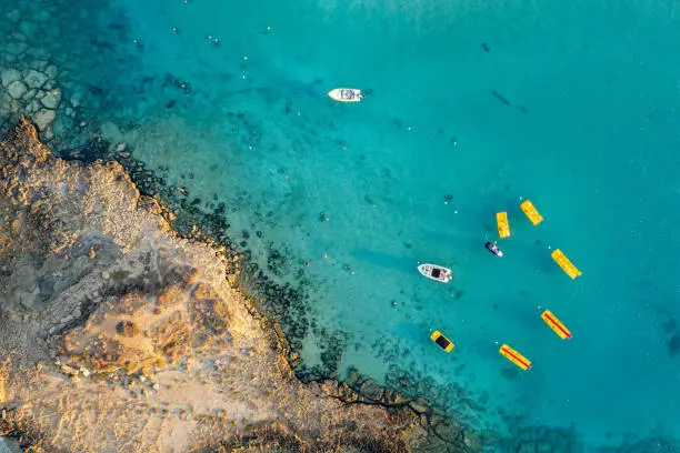 Aerial drone photograph of watersport boat equipment at fig tree bay beach cyprus