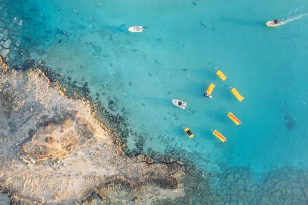 Aerial drone photograph of watersports in the sea at fig tree bay beach cyprus