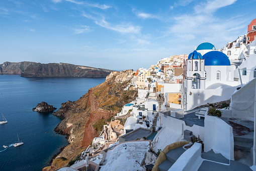 View of Oia in Santorini, the most famous village of the island with the typical white houses and blue domed churches
