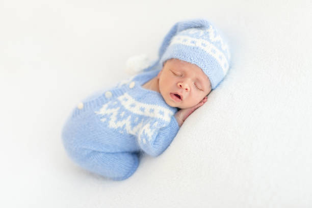 istock Lovely newborn in knitted suit 1406075235