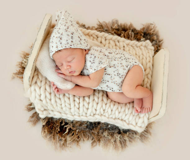 istock Dreamy newborn baby sleeping on bed 1406076319