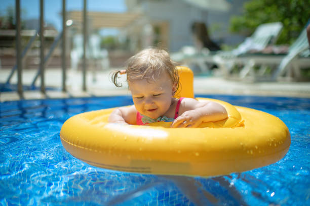 istock Cute baby girl in inflatable ring 1406077975