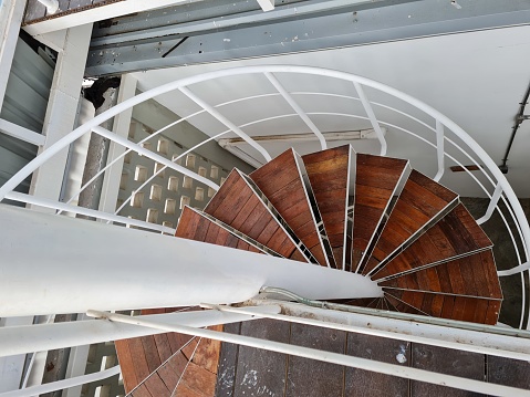 Indoors cherry wooden loft staircase steel structure spiral.