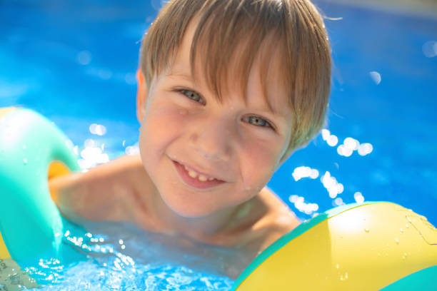 istock Cute little boy in a swimming pool 1406083956
