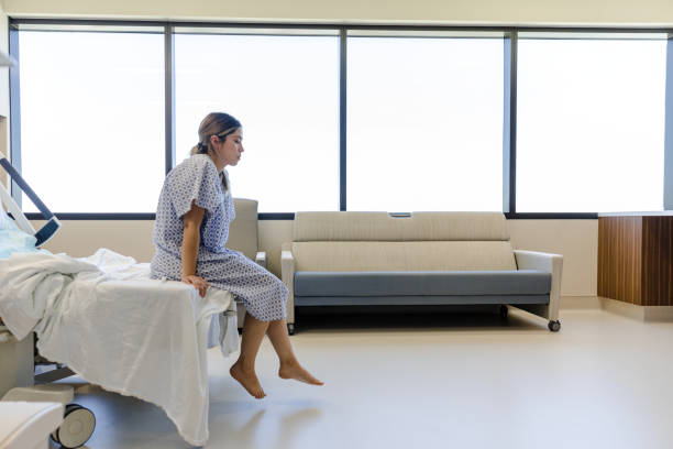 istock Female patient sits alone in hospital room 1406085033