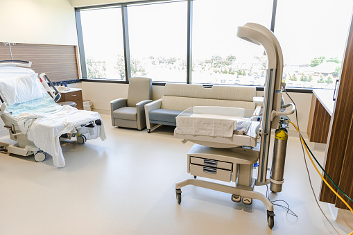 Color image of an empty hospital room that is prepared for newborn delivery later today.