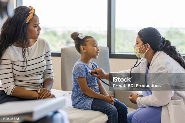 Doctor examines her young patient