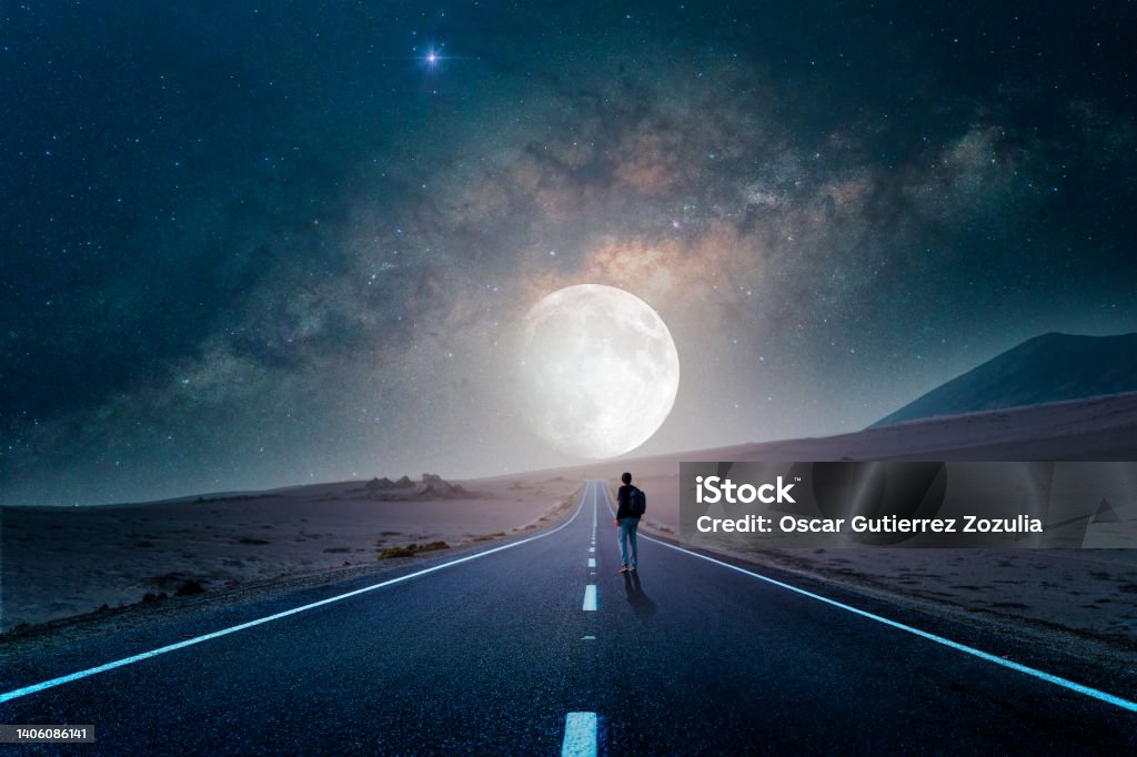road to the moon in the desert at night with silhouette of a person Moon Stock Photo