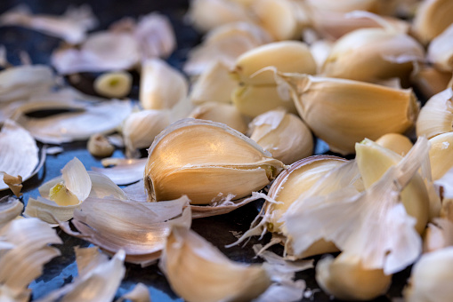 Kitchen counter top with a bunch of unpeeled garlic cloves