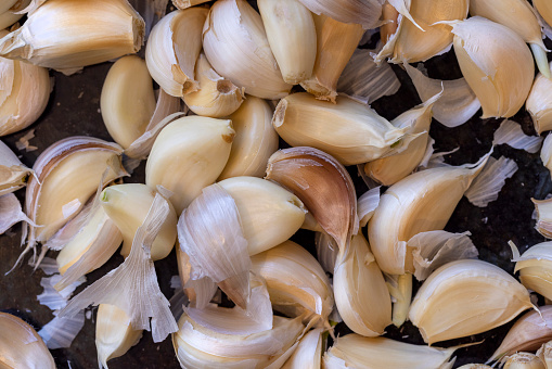 Kitchen counter top with a bunch of unpeeled garlic cloves