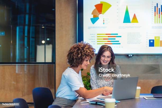 Business Colleagues Working Together On A Laptop Stock Photo - Download Image Now - Finance, Accountancy, Data