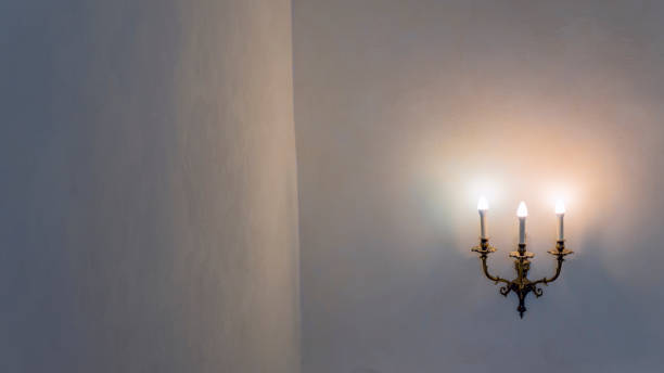 istock Vintage wall lamp. Space for text. Lamp light on the wall. Working lamps at dusk. 1406092949
