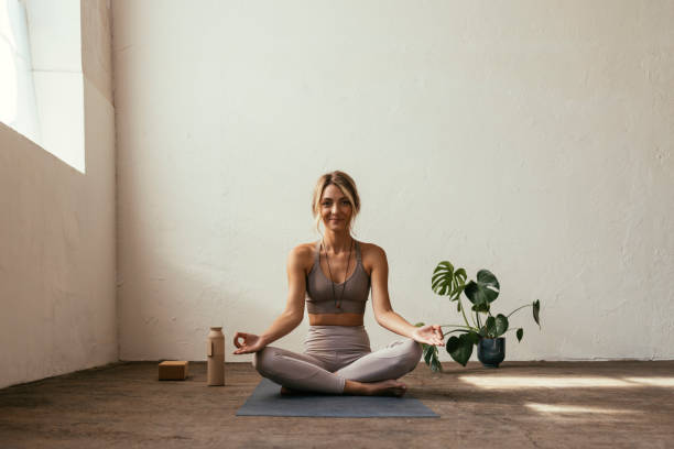 istock Blonde Woman Practicing Yoga At Home 1406094905