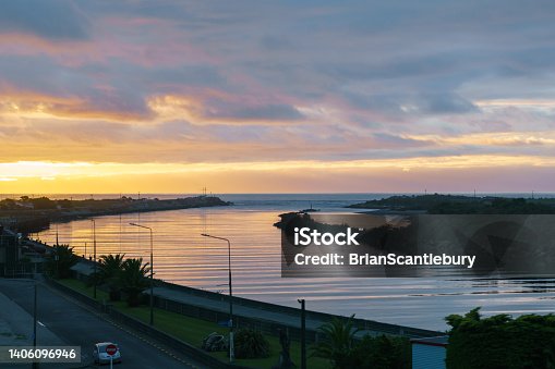 istock Dark cloudy sky in sunset colours over Grey River and West Coast 1406096946