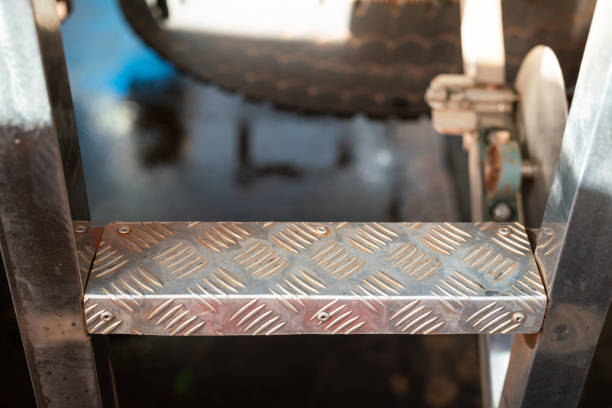 Close-up at the climbing step ladder of a trailer truck or crane machine. Industrial and transportation part object photo.