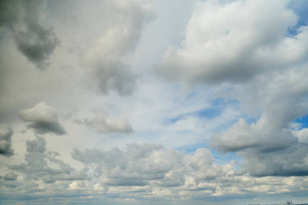 istock White cumulus clouds in the blue sky. Bright beautiful sky, copy space background 1406106077