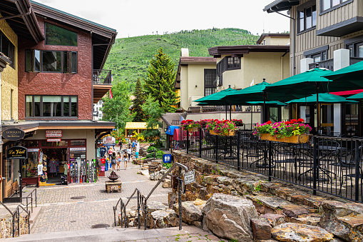 Vail, USA - June 29, 2019: Steps stairs down on Gore Creek drive street with people in shopping area stores shops in Colorado