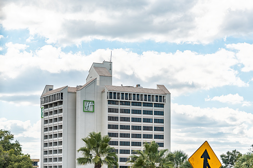 Orlando, USA - October 19, 2021: Building sign for Holiday Inn Express hotel in Florida city near Lake Buena Vista city in summer sunny weather with clouds in blue sky