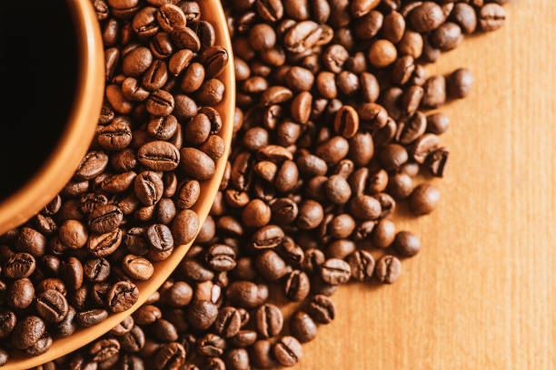 istock coffee background. coffee mug. copy space with coffee beans. coffee beans on the dining table. closeup of coffee beans. coffee beans on a plate 1406111510