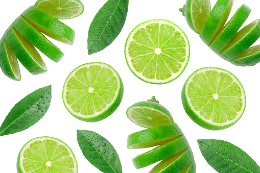 Green lime slices with leaf has water drop pattern isolated on white background.