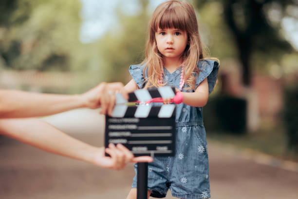 Toddler Girl on a Scooter Acting in Front of the Camera Little child star playing in a commercial rehearsing the scene actress audition stock pictures, royalty-free photos & images