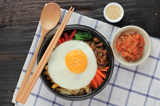 Bibimbap, Korean Spicy Salad with Rice and Fried Egg,  Traditionally Korean Mixed Rice Food Style. Top View