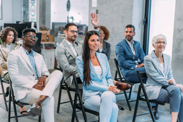 istock Businessman wants to ask a question on a seminar. 1406122861