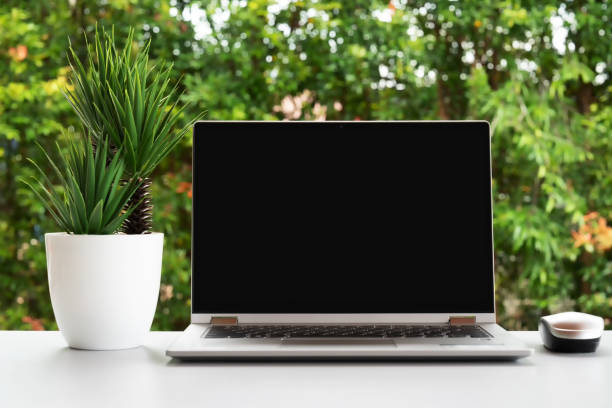 istock Laptop with blank black screen of top of table 1406127428
