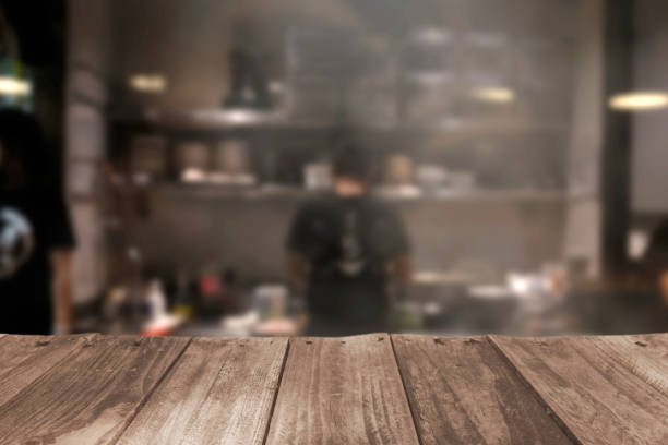 istock Wood top table blur kitchen in restaurant background. 1406136047