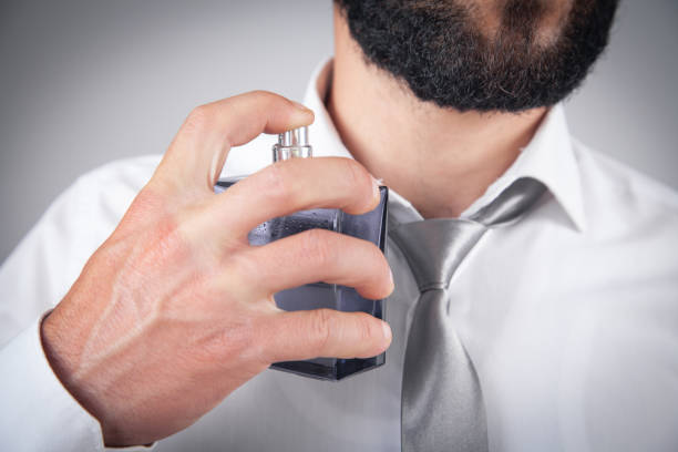 istock Caucasian elegant man spraying perfume. 1406138122