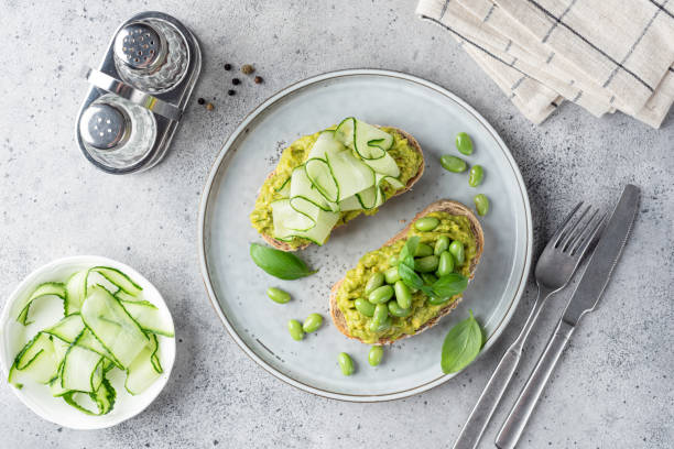 istock Top view of two avocado toasts with toppings 1406139756
