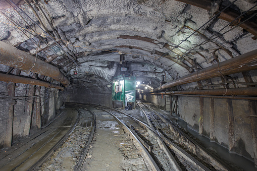 Underground railway for transporting ore. Mine trolley as part of train in iron ore mine.