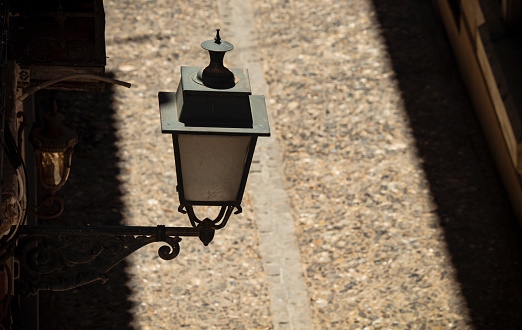 High angle view of street lamp with sunlight and shadow. Granada, Spain