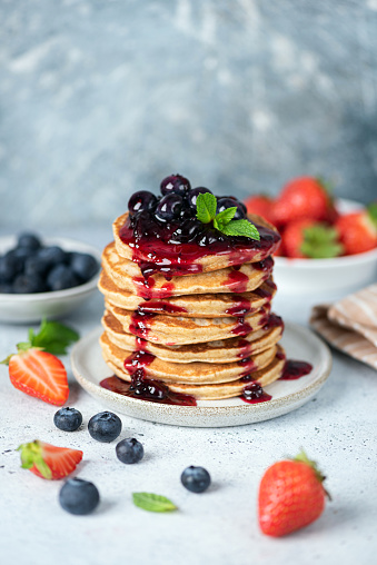 Breakfast healthy oatmeal pancakes topped with berry fruit blueberry strawberry jam