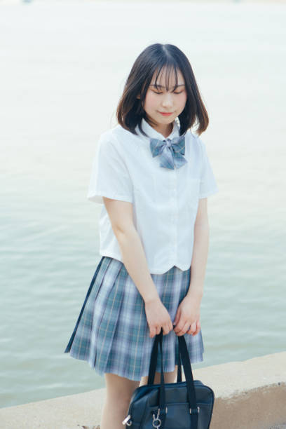 istock Students in uniform who travel by the sea on vacation 1406143192