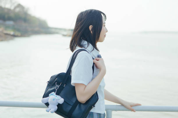 istock Students in uniform who travel by the sea on vacation 1406143502