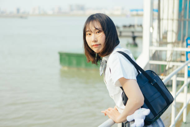 istock Students in uniform who travel by the sea on vacation 1406143753