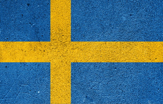 National flag of Sweden on a plastered wall