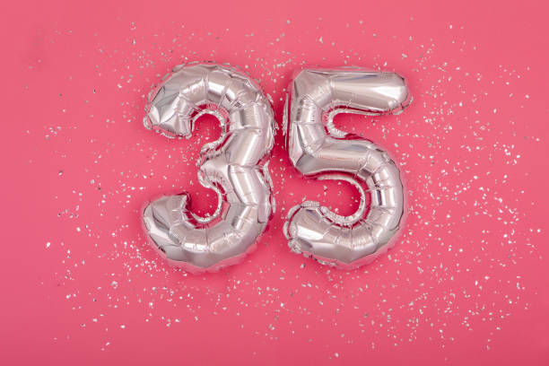 istock Silver balloon shape of number thirty five 35 pink background 1406148294