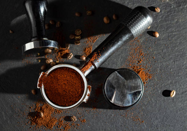 istock Portafilter with coffee and temper on table 1406148371
