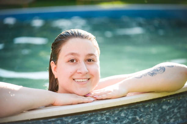 istock young woman in the pool 1406148440